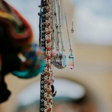 Close-up of handcrafted necklaces with colorful crystals in Antigua Guatemala.