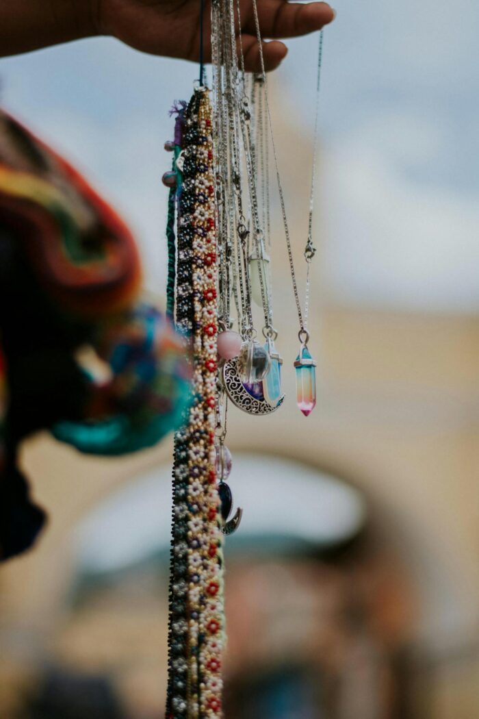 Close-up of handcrafted necklaces with colorful crystals in Antigua Guatemala.